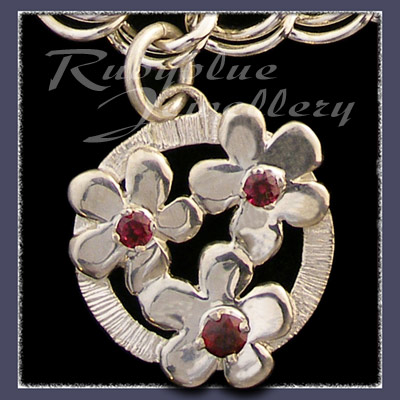Sterling Silver 'Circle of Flowers' Charm with January Birthstones Image