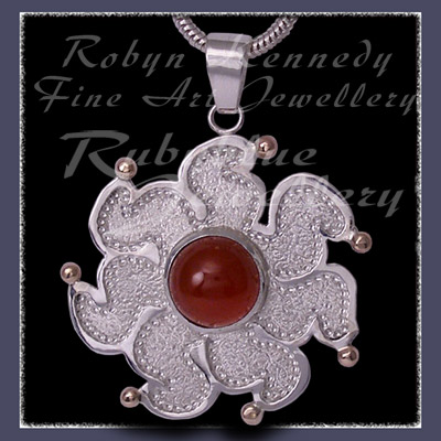 10 Karat Yellow Gold, Sterlling Silver and Carnelian 'Sun' Pendant Image